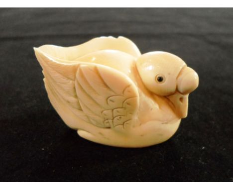 A Meiji period netsuke of a large crested duck, seated, 5cm long, signed