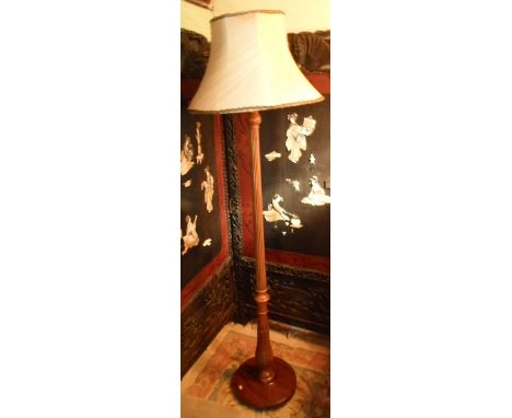 A mahogany standard lamp having reeded column over acanthus leaf stem on circular foot
