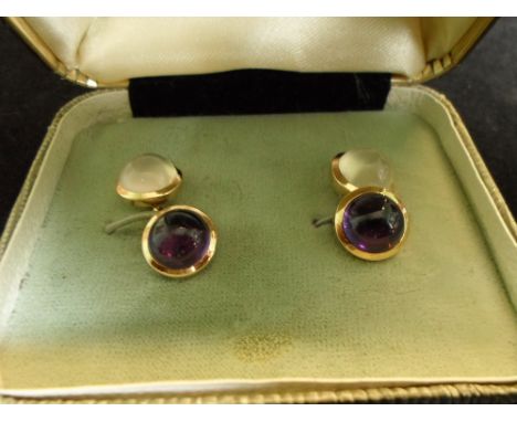 A pair of 18ct gold cufflinks with cabochon moonstone and amethyst terminals Condition Report: Has chain link connections (an
