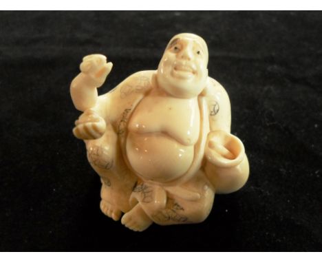A carved Japanese ivory netsuke of a seated buddha, a rat perched on his right arm, 3.5cm, signed