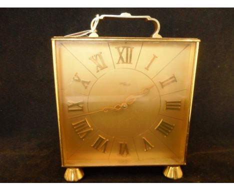 A 20th century gilt Imhof mantel clock, the sectioned dial bearing roman numeral, the case on four circular supports, 19cm ta