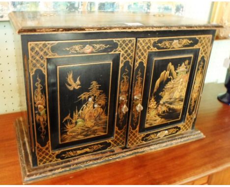 A mid 20th century ebonised wood radio case, chinoiserie decoration, having hinged double doors to the front and a lift-up fl