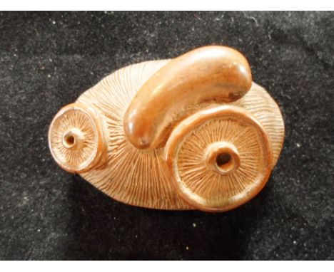 A Meiji period wood carved netsuke of an upturned mushroom, 4cm wide, marked '78'