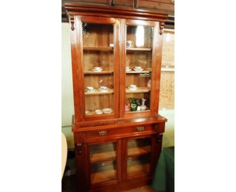 A Victorian mahogany bookcase, having four-shelf upper section over converted cupboard with glazed doors and single drawer on