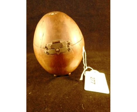 A 19th century coconut tea caddy with hinged cover on four ball supports, the interior retaining elements of lead lining, 12c