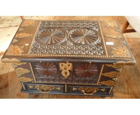 A reproduction brass bound and carved ebonised wood trunk, 66cm x 42cm x 42cm