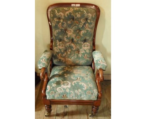 A Victorian mahogany reclining armchair with slide-out foot rest, having upholstered button back seat and arm rests, stamped 