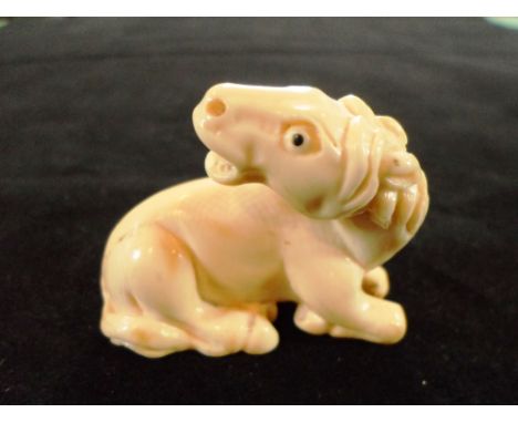 A Japanese ivory netsuke of a recumbent horse, his head turned and mouth open, 4.2cm, unsigned