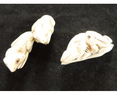 Two Meiji period ivory carved netsuke, each of frogs, both pairs with applied eyes, the largest 6.5cm long, both signed Condi