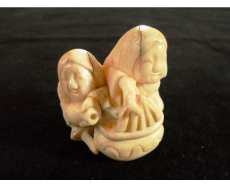 A 19th century Japanese walrus ivory carved netsuke of two seated washer women, 4cm wide, signed