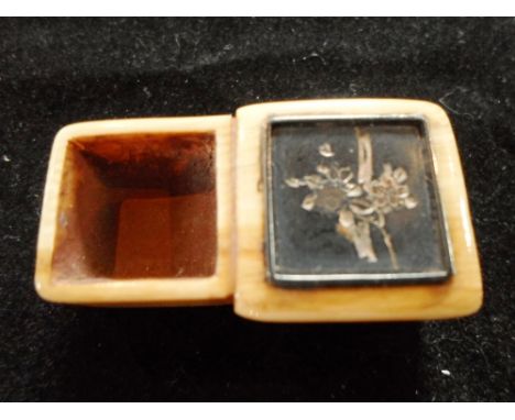 A Meiji period ivory netsuke of two conjoined boxes, one with integral metal and inlaid cover 3.7cm long, insigned