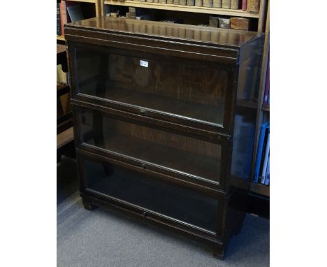 * Bookcase. A 1920s Globe Wernicke oak bookcase, comprising 3 tiers each with hinged glass door with transfer print manufactu