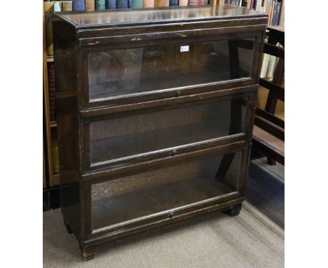 * Bookcase. A 1920s Globe Wernicke oak bookcase, comprising 3 tiers each with hinged glass door with transfer print manufactu