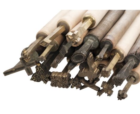 * Decorative finishing tools. 25 brass decorative finishing tools, including centre and corner tools, majority unnamed, three