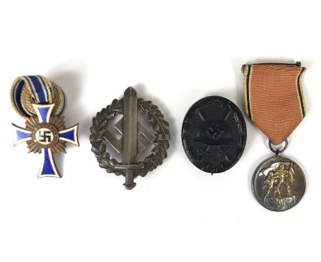 German Third Reich Mothers Cross, Entry into Austria Medal, SA Sports and Wound Badge.  Mothers Cross 3rd class in bronze orn