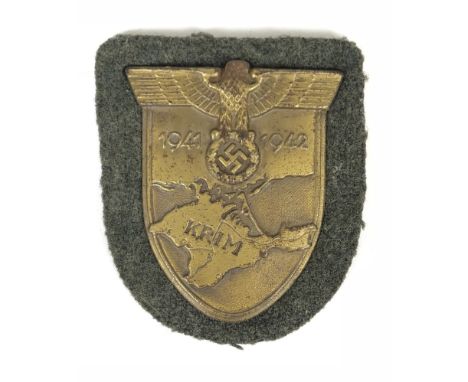 German Third Reich WW2 Army / Waffen SS issue Krim arm shield.  Good scarce bronzed example set on field grey cloth. Eagle an