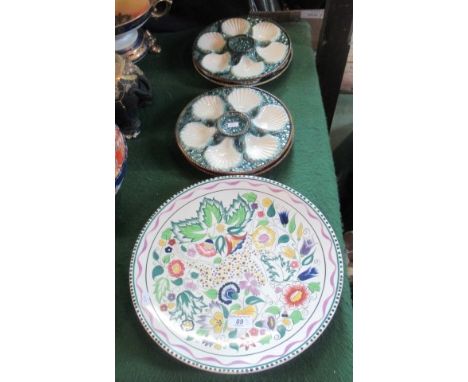 A large Poole charger with foliate decoration, together with four oyster dishes of shell shaped form.   Condition Report:  Ov