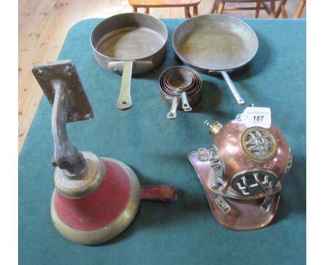A 19th century brass bell, together with a collection of copper saucepans and a child's deep sea diving helmet.