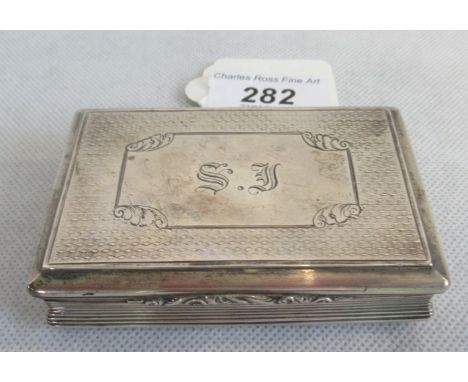 A silver box having hinged lid, the engine turned decoration having central panel to the top (initialled) with reeded edges a