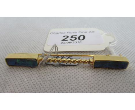 Pippa Ramsay-Rae:  An 18ct gold and boulder opal jabot pin, with rectangular terminals and twisted told bar.