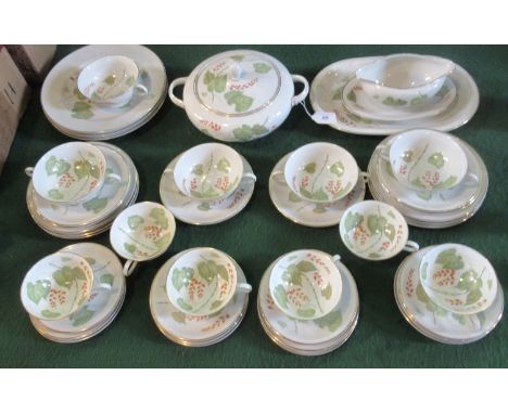 A part Bavarian tea service with foliate decoration, comprising: soup bowls, dinner plates, lidded tureen and a gravy boat.
