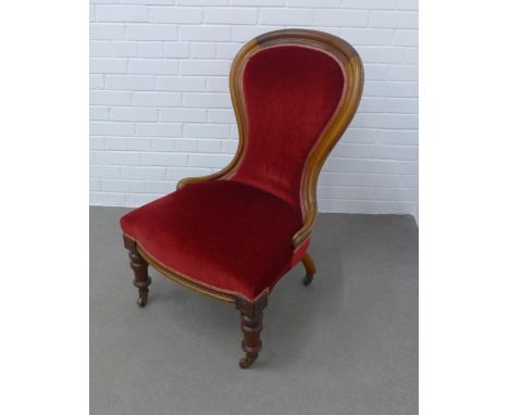Victorian mahogany spoonback nursing chair, upholstered in red velvet, with brass caps and ceramic castors,  62 x 97 x 47cm 