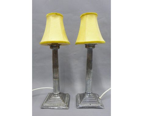 A pair of Epns Corinthian column table lamp bases, with yellow shades, 44cm including shades, (2) 