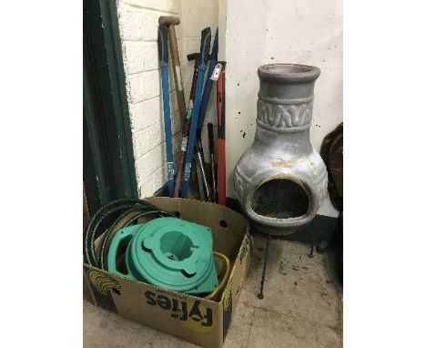 A chiminea, hose pipe on reel, garden tools and a Forge Steel axe 