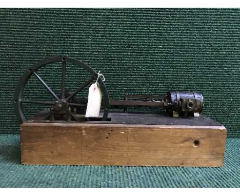 A hand-built steam piston engine on wooden stand