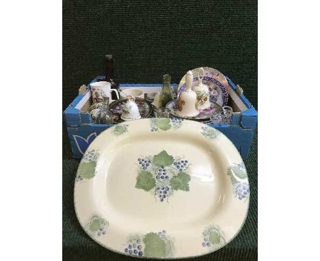 A box of collector's plates, china and glass bells, oak canteen, Poole pottery meat plate 