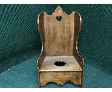 An antique pine child's rocking commode chair 