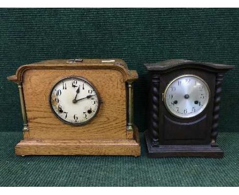 An early twentieth century inlaid oak bracket clock, together with another oak mantle clock of similar age. (2)