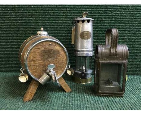 A Pattersons number 3 miner's lamp, antique oil lamp and an oak whiskey barrel on stand 