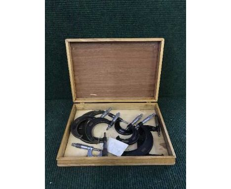 A wooden cutlery canteen of eight assorted precision measuring tools 