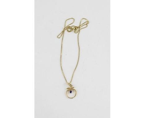 An 18ct. yellow gold and sapphire pendant, realistically fashioned as an apple, four claw set single round cut sapphire, impr