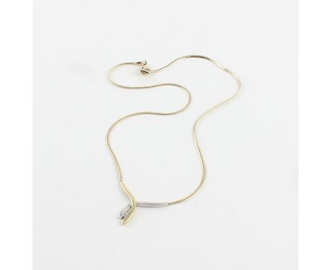 A 9ct. two-tone gold and diamond necklace, fashioned from a tapering serpentine yellow gold bar overlaying a similarly taperi