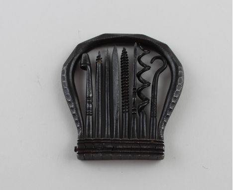 A 19th century steel pocket tool, the faceted horseshoe shaped handle enclosing eight various fold-down tools hinged to base,