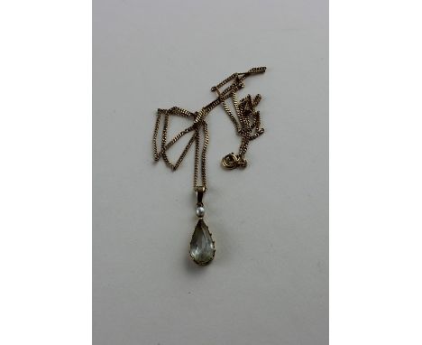 A 14ct. yellow gold, aquamarine and seed pearl pendant, claw set pendeloque cut aquamarine with single seed pearl above, bail