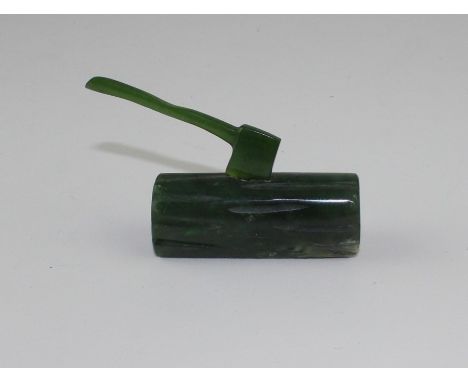 A 20th century dark green jade paperweight, fashioned as an axe in wood log, this with carved bark and end grain detail. heig