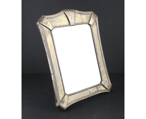 An Arts &amp; Crafts silver mirror, by Elkington &amp; Co Ltd, assayed Birmingham 1908, having shaped and ribbed border with 