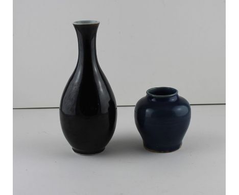 Two Chinese porcelain monochrome to include a late Ming/early Qing, probably 17th century dark blue waisted jar vase, and a l