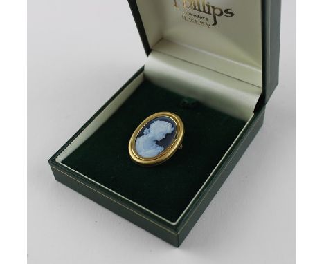 An 18ct. yellow gold oval cameo brooch,&nbsp;the cameo of black jasper ware style and of a profile bust of a young woman look