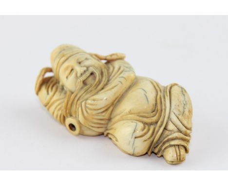 A late 19th century Chinese ivory Lohan, the recognisable figure in recumbent pose, 6.5 cm long