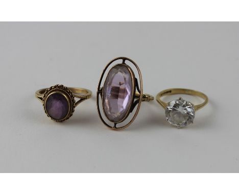 A 9ct. gold and amethyst ring, having central oval cut amethyst in rub over setting surrounded by a chain link border, (gross