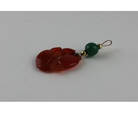 Chinese yellow metal and red jade pendant, having red jade pendant fashioned as stylised fruits to leafed stem, suspended fro