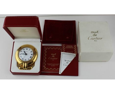 A Cartier Colisee travel alarm clock, c.1992, having signed white enamel Roman numeral dial with outer minutes track, 78mm wi