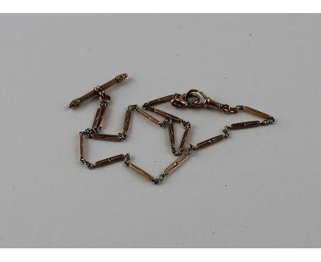 A 9ct. gold long and short link watch chain, formed from yellow gold long links alternating oval white metal links, suspendin