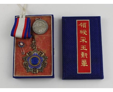 A Taiwan/China silver gilt and enamel medal, relief cast and impressed character marks and stamped "14", diameter 62mm, with 