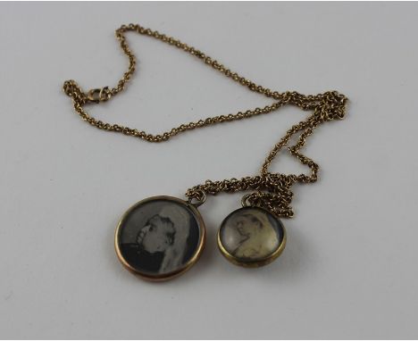 A 9ct. gold circular pendant, containing a photograph of Queen Victoria to one side and Prince Albert to the other, both unde