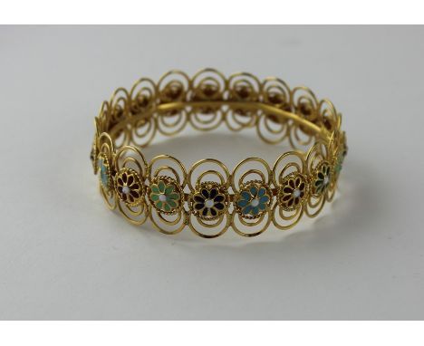 A 21ct. yellow gold and champleve enamel circular bracelet, fashioned as a series of champleve enamelled flowers coloured in 